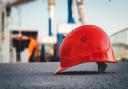 Stock image of a construction helmet on the ground. Photo: Unsplash/Ümit Y?ld?r?m