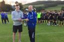 Ian Fergus collects the Billy Pringle Memorial Cup from Liam Pringle