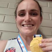 Stacey Downie celebrates with a gold medal