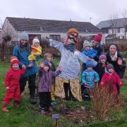 Greener Peebles' Grow Kids group with one of their new scarecrows