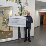 James Mcalpine and cheque for £8,240. Photo courtesy of Jame Mcalpine