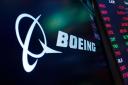 The logo for Boeing appears on a screen above a trading post on the floor of the New York Stock Exchange (Richard Drew/AP, file)