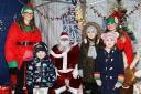 Father Christmas with elves, and Carly Wallis age 4
and Quinn Wallis age 6. Photos: Helen Barrington