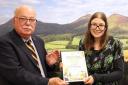 Councillor John Greenwell presenting the award to Greener Peebles Project Manager Nichole Dow Photo AndersonDrummond Photography