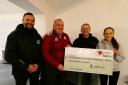 Left to right, Gala Rugby’s Sinclair Paterson and Gary Isaac, hand over a £1,000 cheque to Dave and Kristin Boland of the Rowan Boland Memorial Trust
