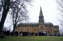 Guests outside Melrose Parish Church before a memorial service for Doddie Weir in Melrose, Scotland. Doddie Weir died aged 52 on the 26th November after suffering from motor neurone disease. Issue date: Monday December 19, 2022.