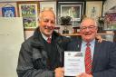 Ross Buchan receives his lifetime membership certificate from Jim Gray - Photo Thomas Brown
