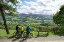 Cyclists enjoy the view over the Tweed valley from Glentress  Forest. Photo: VisitScotland