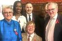 HIV campaigner and music superstar Sir Elton John, seated, with husband David Furnish, back, third from left, and parliamentarians, left to right: committee co-chairs Baroness Liz Barker, Florence Eshalomi MP and David Mundell MP