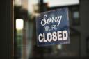 Stock image of a closed sign on a glass door. Photo: Unsplash/Tim Mossholder