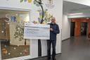 James Mcalpine and cheque for £8,240. Photo courtesy of Jame Mcalpine