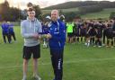 Ian Fergus collects the Billy Pringle Memorial Cup from Liam Pringle