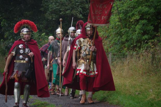 Border Telegraph: The Antonine Guard visited West Linton last year to support campaigners against the quarry. They're photographed marching along the old Roman Road. Photo: Quarries Action Group