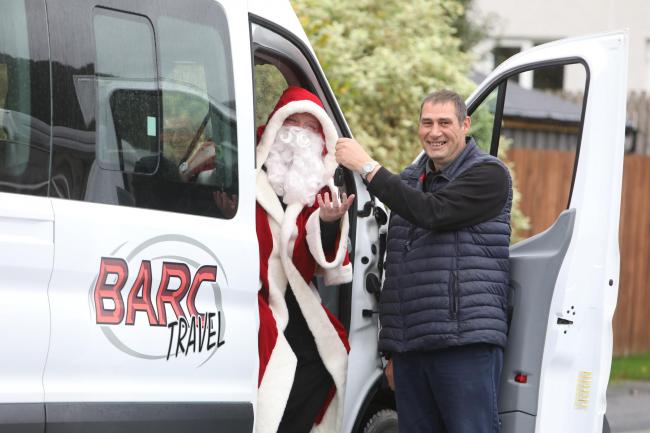 Keith Gibb, of Barc Travel, handing Father Christmas keys to the mini bus/taxi. Photo: Helen Barrington