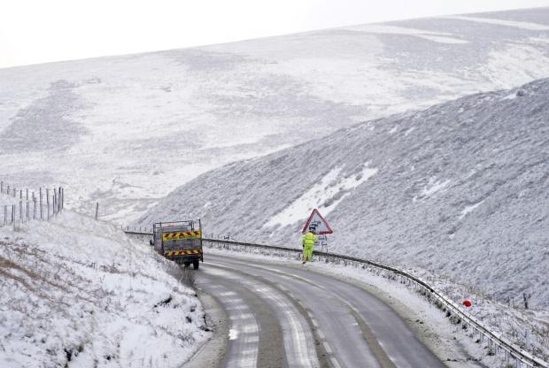 Border Telegraph: Snowy road and hills. Credit: PA