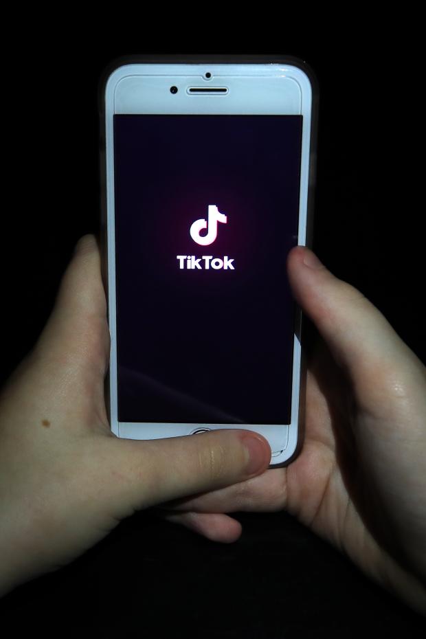 Border Telegraph: A person with TikTok open on their phone. Credit: PA