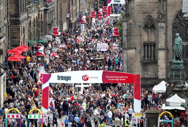 Border Telegraph: Crowds on Edinburgh's Royal Mile. Credit: Jane Barlow/PA