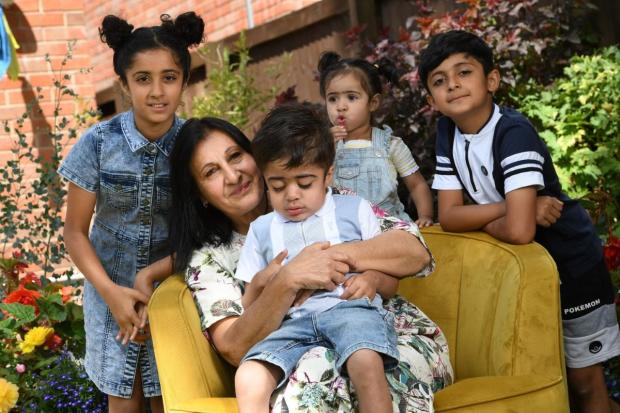 Mikaeel Khan pictured with his grandma Amina Khan and siblings. Picture: T&A