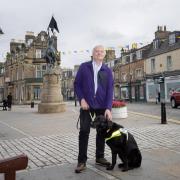 Ian Hamilton and his guidedog Major in Hawick. Photo: BBC Scotland