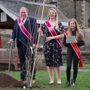 Peebles Cornet 2022, Iain Mitchell, Cornets Lass 2022 Becca Lumsden and Beltane Queen 2022 Elena Chrystie at the planting of a tree from the Queen Elizabeth Platinum Jubilee Green Canopy on Tweed Green, Peebles. Photo: Peebles Beltane Festival