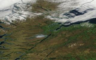 Screenshot from Nasa worldview satellite showing the plume of smoke (centre) from the fire at Cannich, in the hills above Loch Ness in the Highlands, drifting towards the loch on Monday amid clear skies